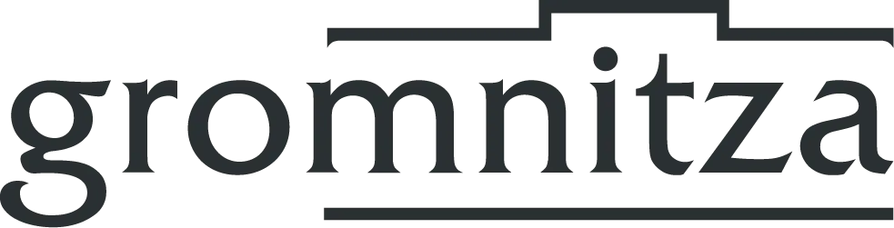 Gromnitza-Logo in schwarzer Serifenschrift mit stilisiertem Dachsymbol und Untertitel „IKT SYSTEMHAUS“.